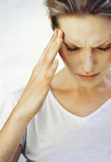 A woman having a headache because of her TMJ problem