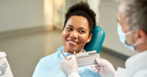 Female patient reviews veneers with dentist